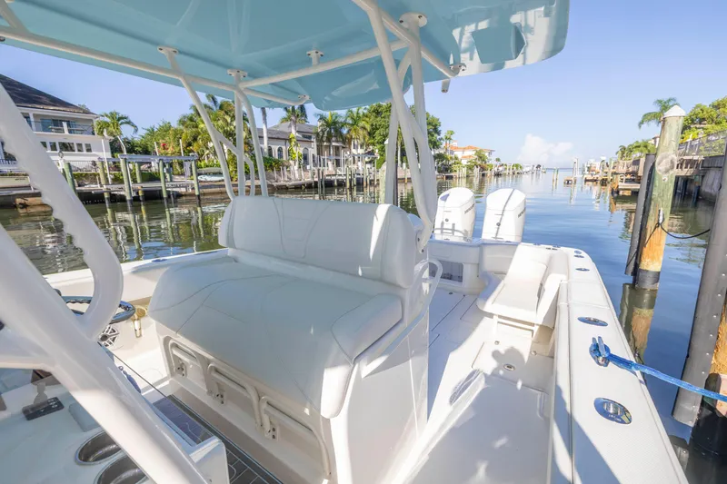 Slide: The Image of 2022 SeaVee 390Z boat with white seating, docked in a sunny marina. - 36