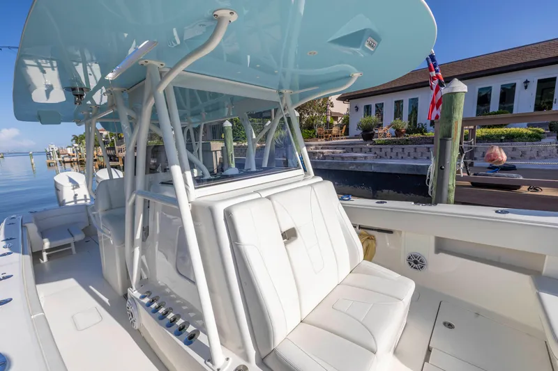 Slide: The Image of 2022 SeaVee 390Z boat with sleek seating and canopy docked by waterfront homes. - 38