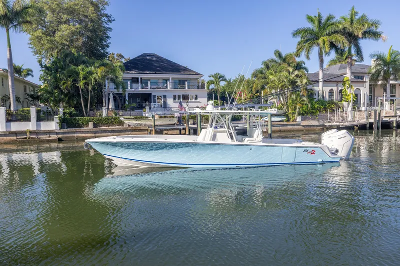 Slide: The Image of 2022 SeaVee 390Z boat docked in a scenic waterfront setting. - 4