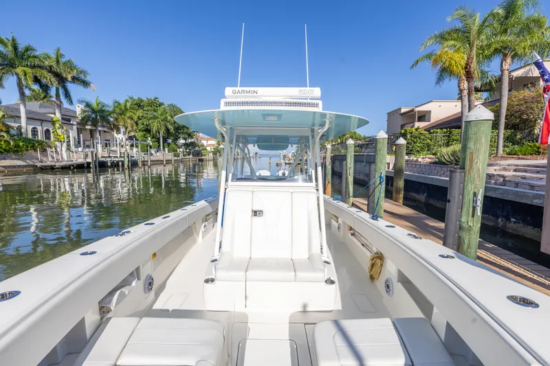 Slide: The Image of 2022 SeaVee 390Z boat docked in sunny marina with palm trees. - 40