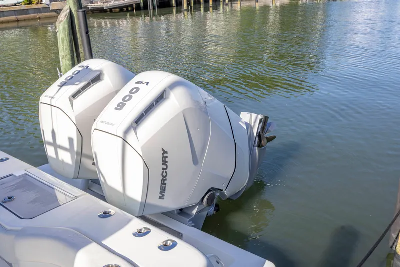 Slide: The Image of Twin Mercury outboard engines on a 2022 SeaVee 390Z boat in calm waters. - 5