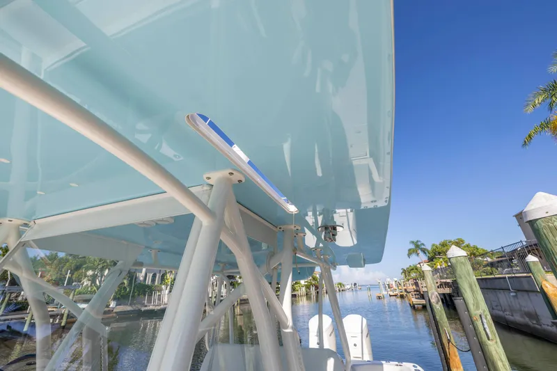 Slide: The Image of 2022 SeaVee 390Z boat docked by a scenic waterfront. - 6