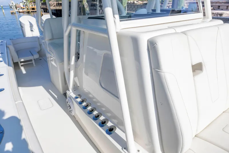 Slide: The Image of 2022 SeaVee 390Z boat interior with white seating and rod holders. - 8