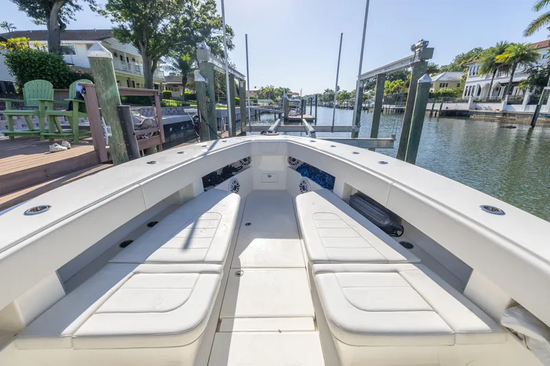 Slide: The Image of 2022 SeaVee 390Z boat interior at a dock, featuring spacious seating and modern design. - 9