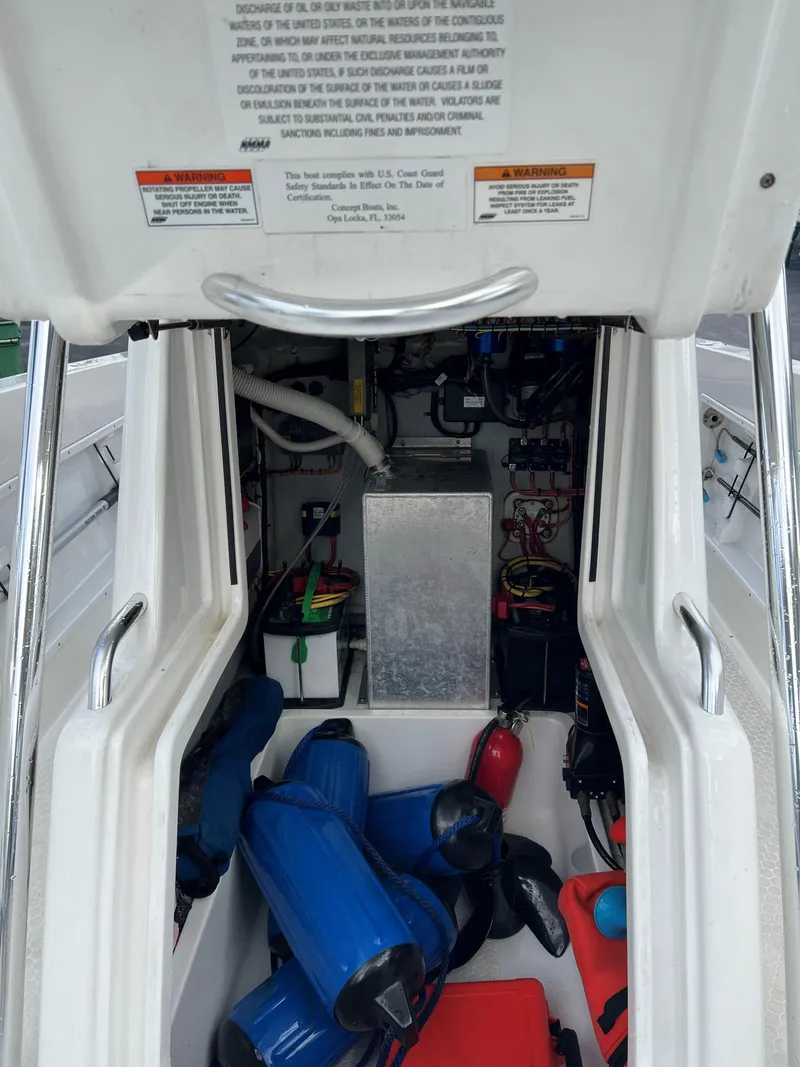 Slide: The Image of Interior view of a 2016 Concept 27' CC boat showing storage and equipment. - 10