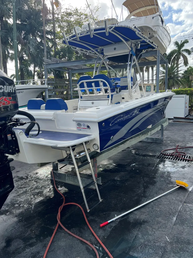Slide: The Image of 2016 Concept 27' CC boat with blue and white design, docked outdoors. - 15