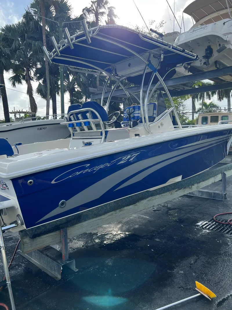 Slide: The Image of Blue 2016 Concept 27' CC boat on lift, palm trees in background. - 16
