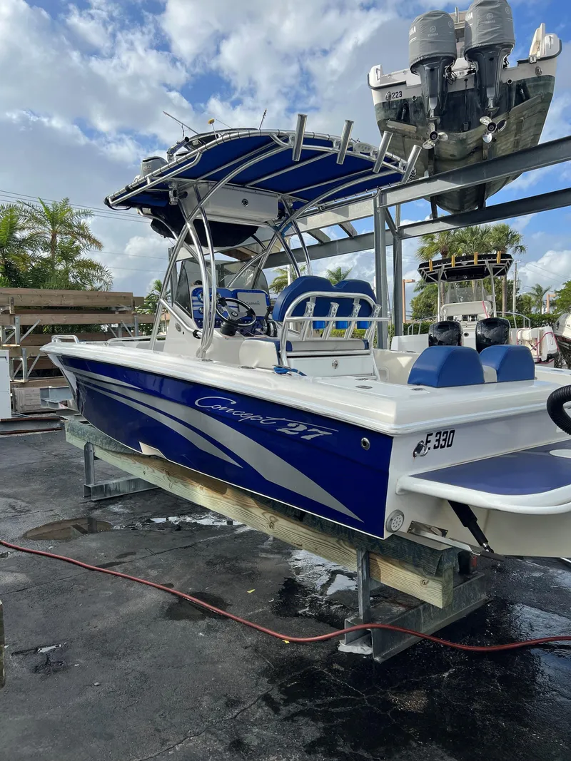 Slide: The Image of 2016 Concept 27' CC boat with blue and white design on a dock. - 18