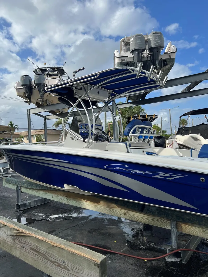 Slide: The Image of Blue 2016 Concept 27' CC boat on a lift under a cloudy sky. - 19