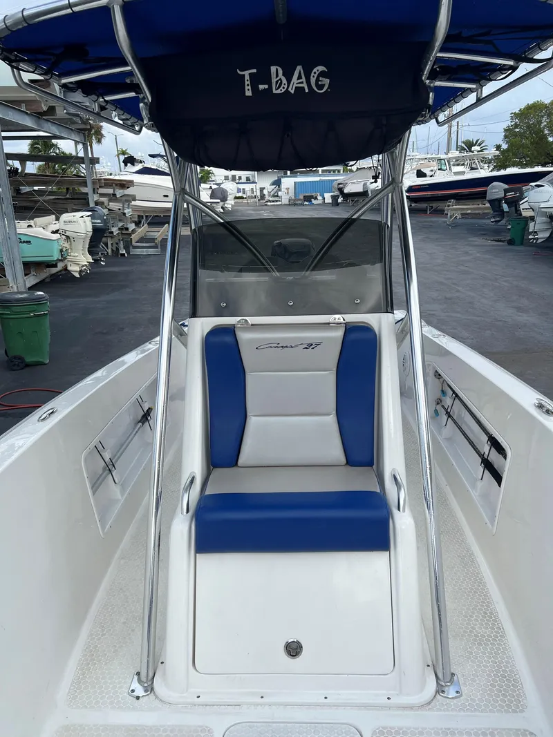 Slide: The Image of 2016 Concept 27' CC boat with blue seating and T-top in marina. - 5