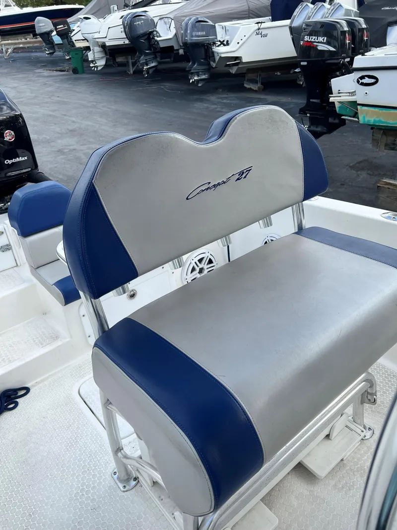 Slide: The Image of 2016 Concept 27' CC boat seat with blue and gray upholstery in a marina setting. - 6