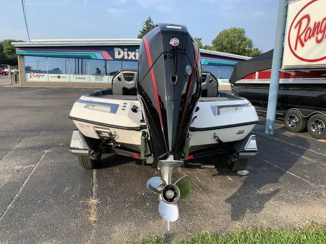 Slide: The Image of 2024 Ranger Z520R boat with powerful outboard motor, parked at dealership. - 6