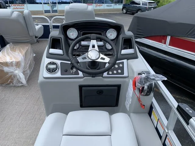 Slide: The Image of 2023 Ranger 220F boat dashboard with steering wheel and gauges. - 4