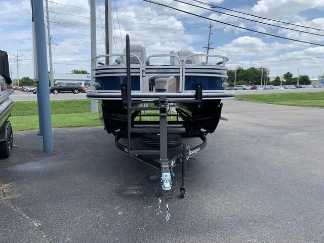 Slide: The Image of 2023 Ranger 220F boat on trailer, parked outdoors under cloudy sky. - 7
