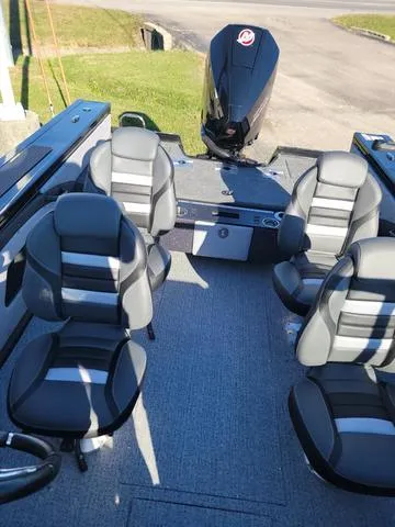 Slide: The Image of 2024 Ranger VX1888L boat interior with four gray seats and outboard motor. - 7