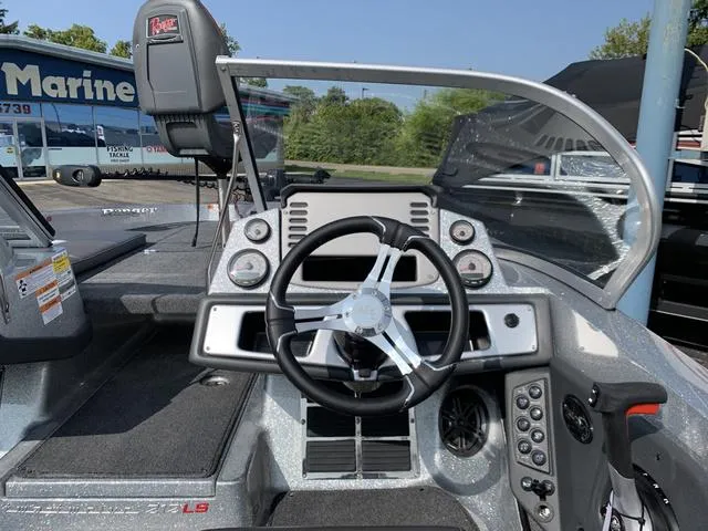 Slide: The Image of 2025 Ranger 212LS boat dashboard with steering wheel and control panel. - 6