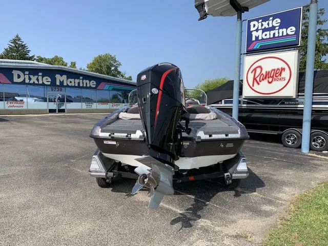 Slide: The Image of 2025 Ranger 212LS boat at Dixie Marine dealership, featuring powerful outboard motor. - 9