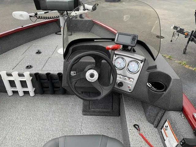 Slide: The Image of 2023 Tracker Pro Guide 16 boat interior with steering wheel and dashboard controls. - 3