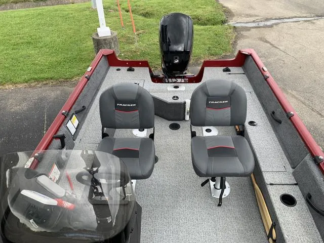 Slide: The Image of 2023 Tracker Pro Guide 16 boat interior with two seats and motor. - 4