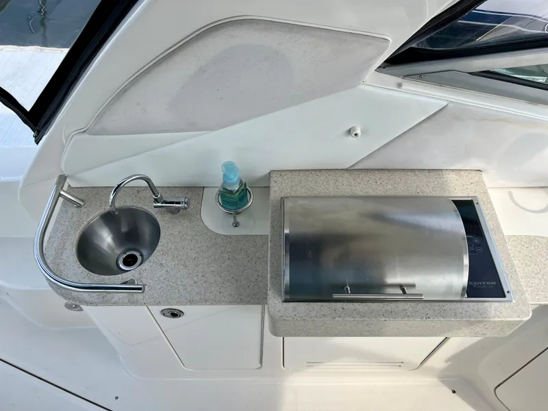 Slide: The Image of 2009 Sea Ray 310 Sundancer boat kitchenette with sink and grill. - 10