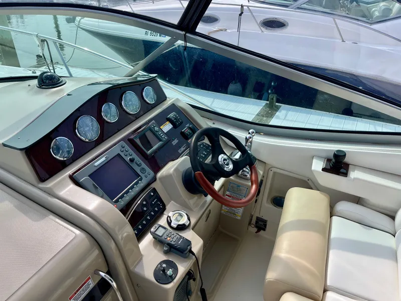Slide: The Image of 2009 Sea Ray 310 Sundancer helm with navigation instruments and steering wheel. - 13