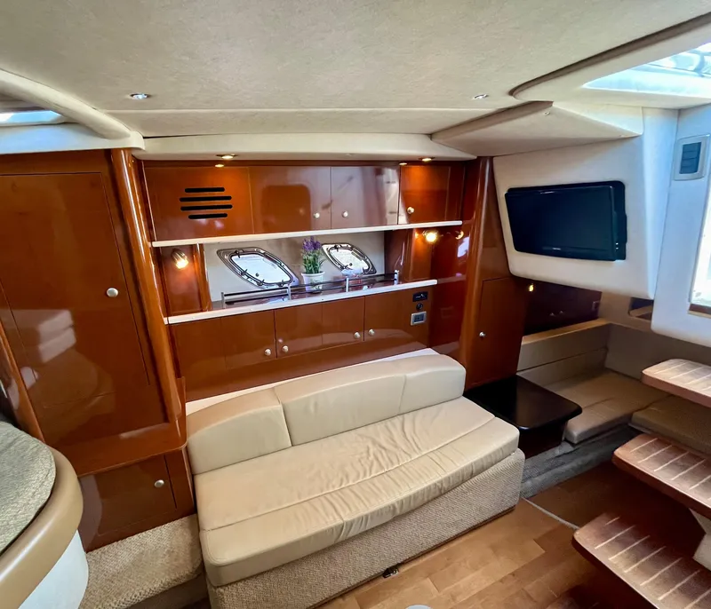 Slide: The Image of Luxurious interior of 2009 Sea Ray 310 Sundancer yacht with seating and entertainment area. - 19