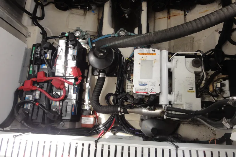 Slide: The Image of Engine compartment of a 2009 Sea Ray 310 Sundancer with visible batteries and wiring. - 29