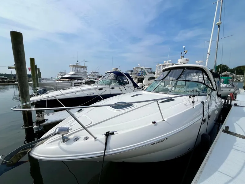 Slide: The Image of 2009 Sea Ray 310 Sundancer docked at marina under clear blue sky. - 3