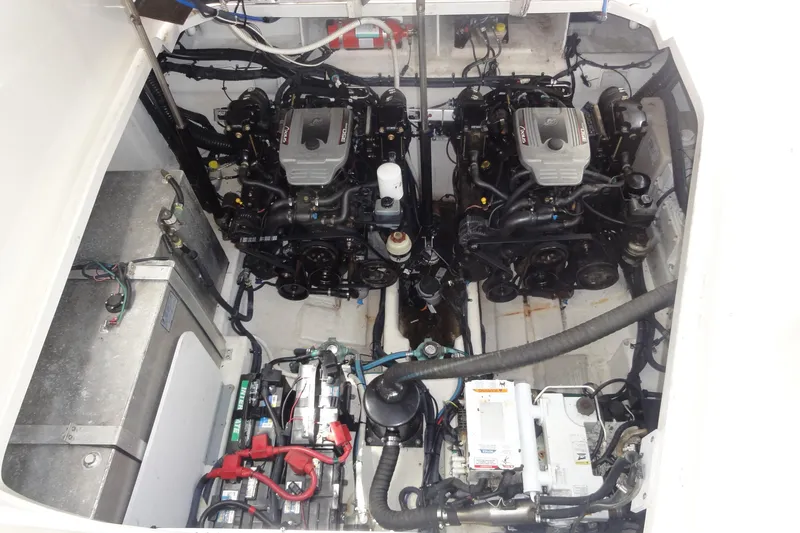 Slide: The Image of Engine compartment of 2009 Sea Ray 310 Sundancer with dual engines and mechanical components. - 32