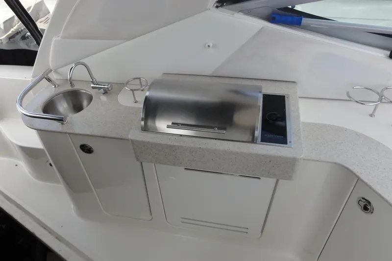 Slide: The Image of 2009 Sea Ray 310 Sundancer boat kitchenette with sink and grill. - 33