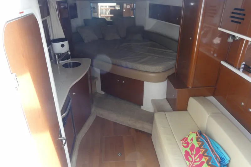 Slide: The Image of Interior of 2009 Sea Ray 310 Sundancer yacht with cozy seating and compact kitchenette. - 35