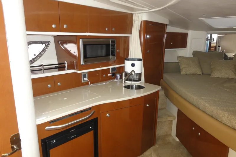 Slide: The Image of 2009 Sea Ray 310 Sundancer interior with kitchenette, microwave, and cozy sleeping area. - 37