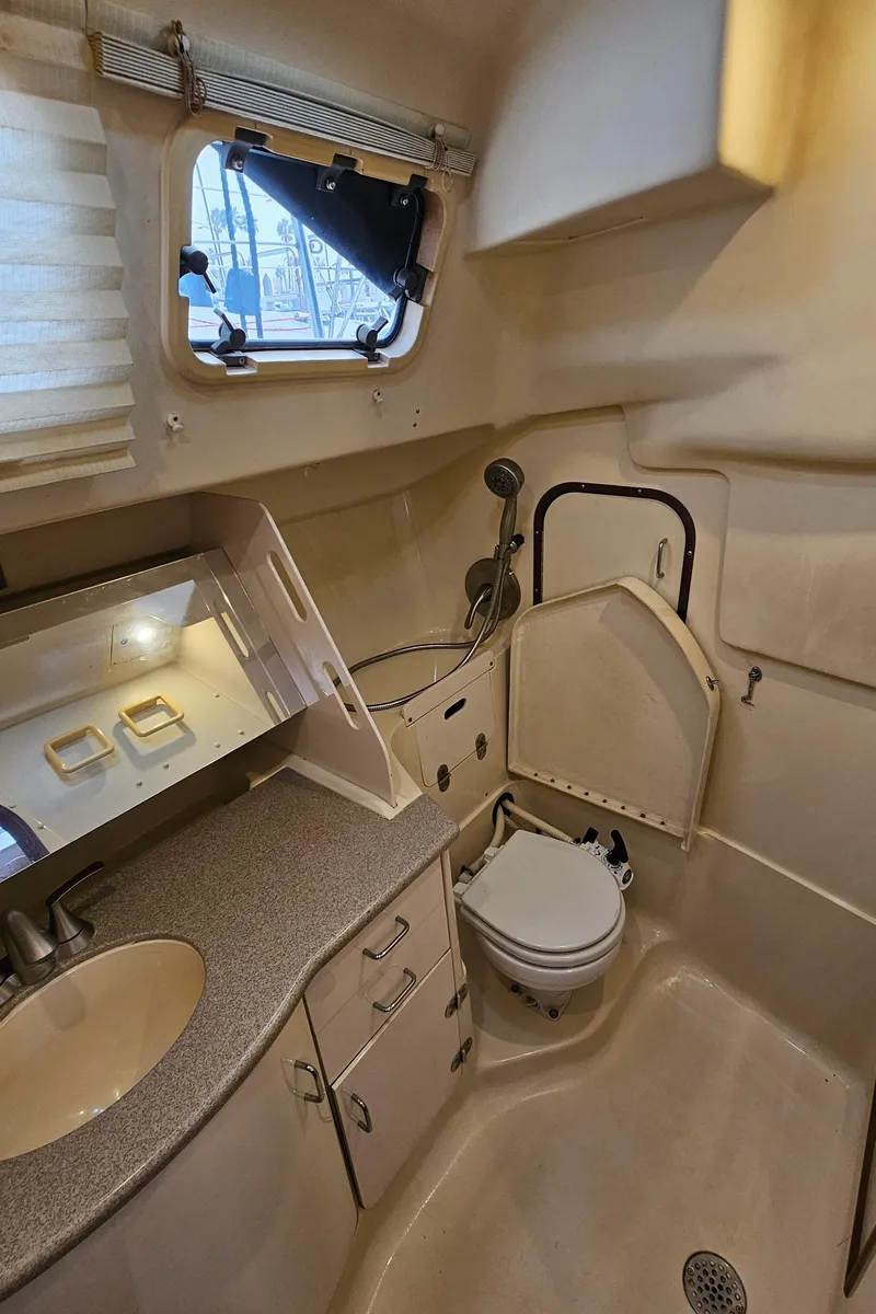 Slide: The Image of Interior of 1998 Hunter 340 Sloop bathroom with sink, toilet, and shower. - 12