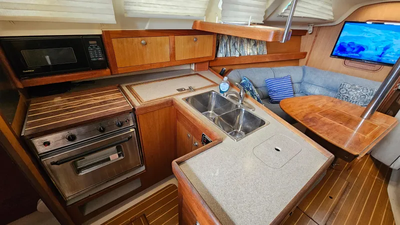 Slide: The Image of Interior of 1998 Hunter 340 Sloop with kitchen, sink, and seating area. - 14