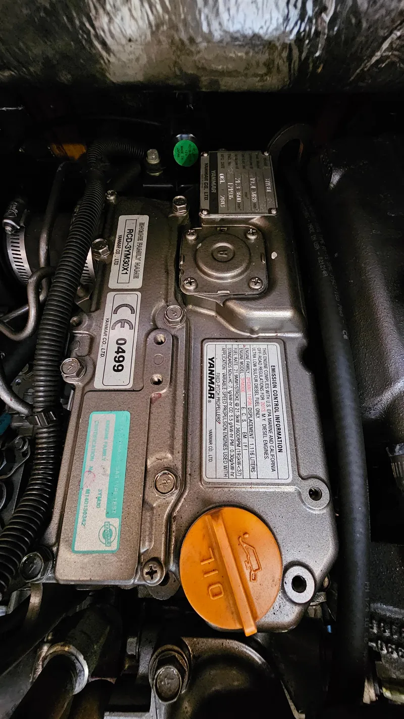 Slide: The Image of Engine of 1998 Hunter 340 Sloop sailboat, detailed view with labels and oil cap. - 16