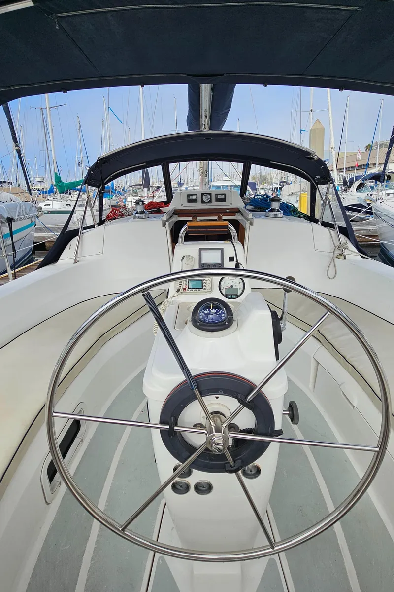 Slide: The Image of 1998 Hunter 340 Sloop cockpit with steering wheel, docked in marina. - 6