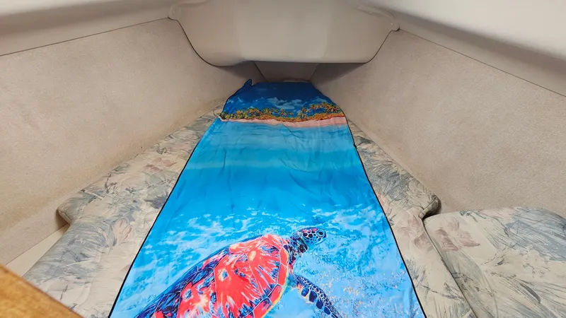 Slide: The Image of Hunter 340 Sloop 1998 cabin interior with vibrant sea turtle bedding. - 8