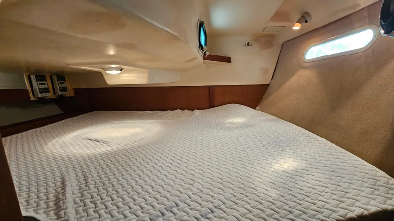 Slide: The Image of Interior cabin of 1998 Hunter 340 Sloop with cozy bedding and porthole windows. - 9