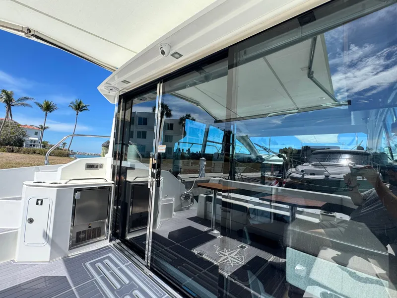 Slide: The Image of 2019 Cruisers Yachts 42 Cantius with sleek glass doors and modern interior design. - 10