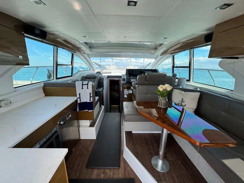 Slide: The Image of Luxurious interior of 2019 Cruisers Yachts 42 Cantius with elegant seating and ocean view. - 12