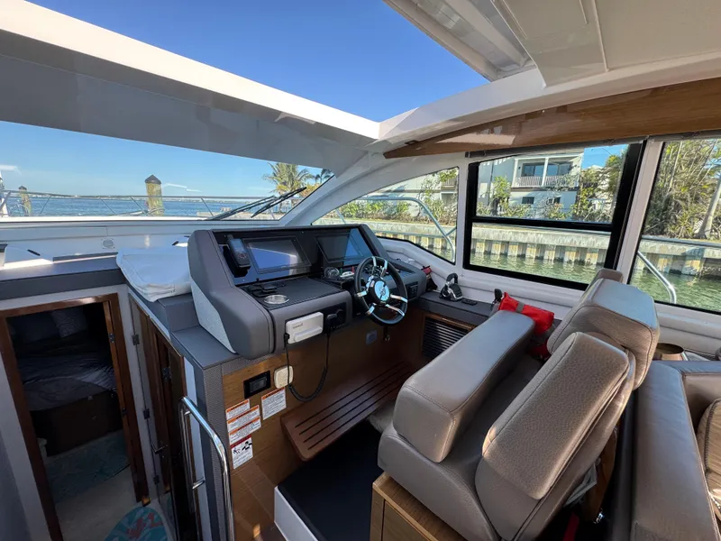 Slide: The Image of 2019 Cruisers Yachts 42 Cantius helm with modern controls and waterfront view. - 16