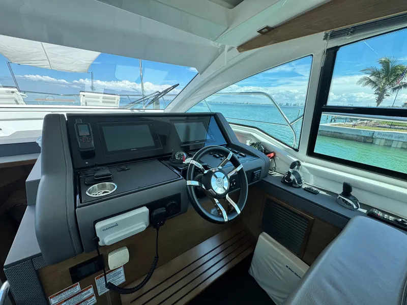 Slide: The Image of Helm of 2019 Cruisers Yachts 42 Cantius with modern controls and ocean view. - 18