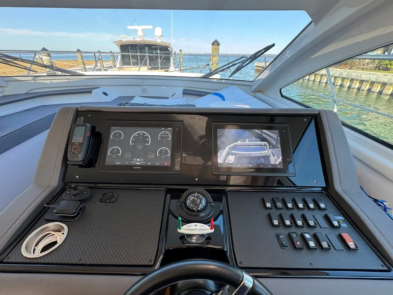 Slide: The Image of 2019 Cruisers Yachts 42 Cantius helm with navigation screens and controls. - 19