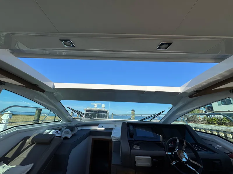 Slide: The Image of Interior view of 2019 Cruisers Yachts 42 Cantius with open sunroof and helm. - 23