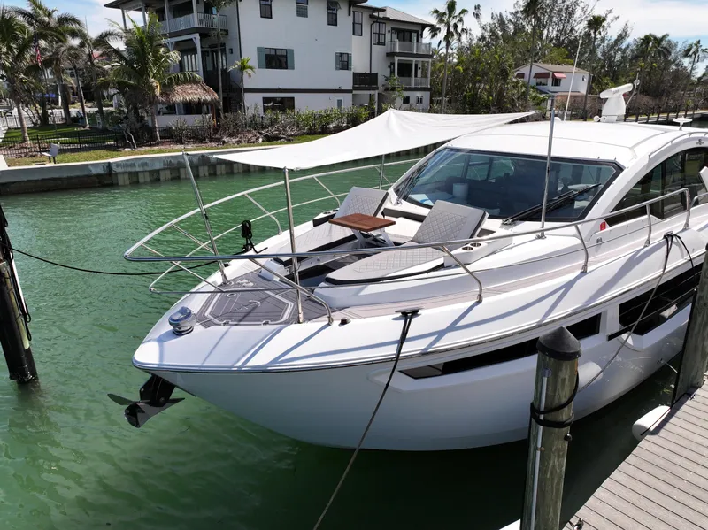 Slide: The Image of 2019 Cruisers Yachts 42 Cantius docked in a scenic marina setting. - 3