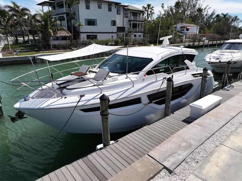 Slide: The Image of 2019 Cruisers Yachts 42 Cantius docked in a scenic marina setting. - 4
