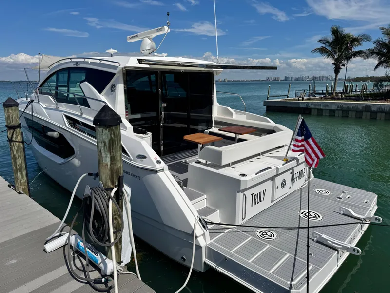 Slide: The Image of 2019 Cruisers Yachts 42 Cantius docked, featuring sleek design and spacious deck area. - 7