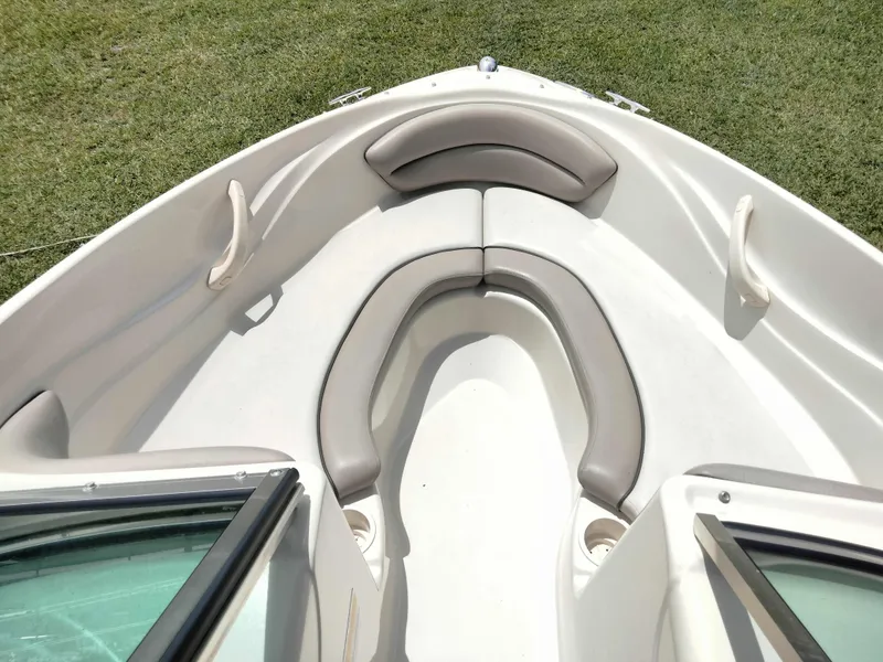 Slide: The Image of 2002 Sea Ray 176 Bow Rider interior with cushioned seating and cup holders. - 10