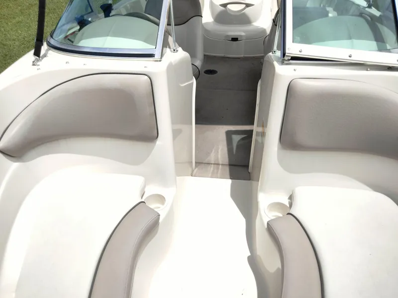 Slide: The Image of 2002 Sea Ray 176 Bow Rider interior with beige seating and open deck layout. - 11