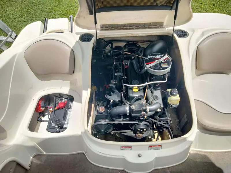 Slide: The Image of 2002 Sea Ray 176 Bow Rider engine compartment with Mercury 3.0 motor, open seating layout. - 16